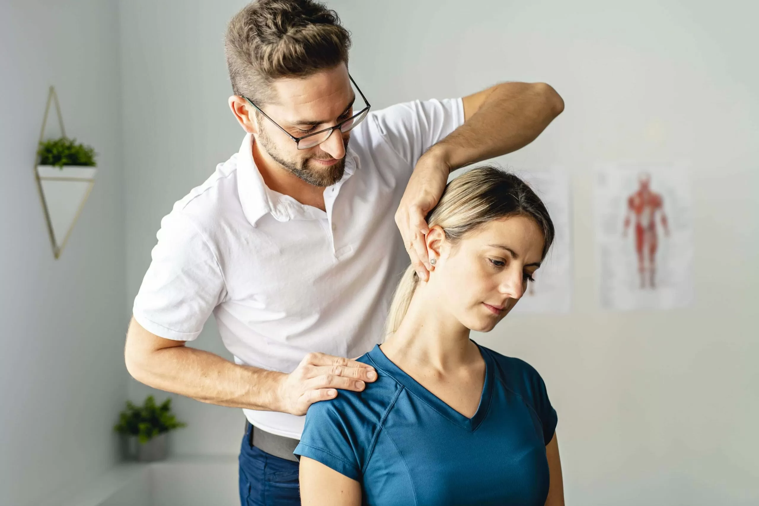physical therapist treating neck pain on woman