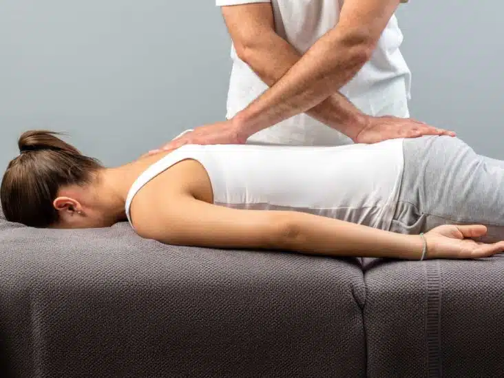 chiropractor helping patient with natural pain management
