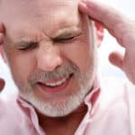 older man experiencing a headache