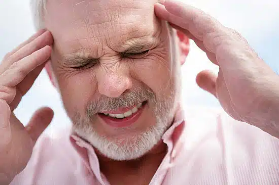 older man experiencing a headache